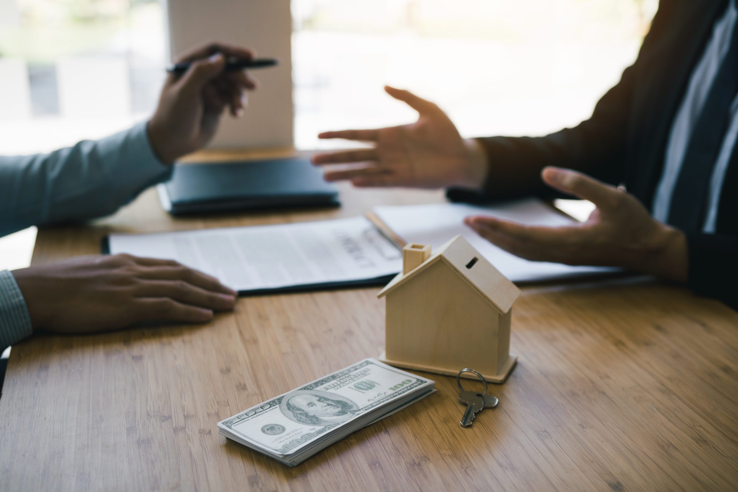 Business people home sales broker is using a pen pointing to the