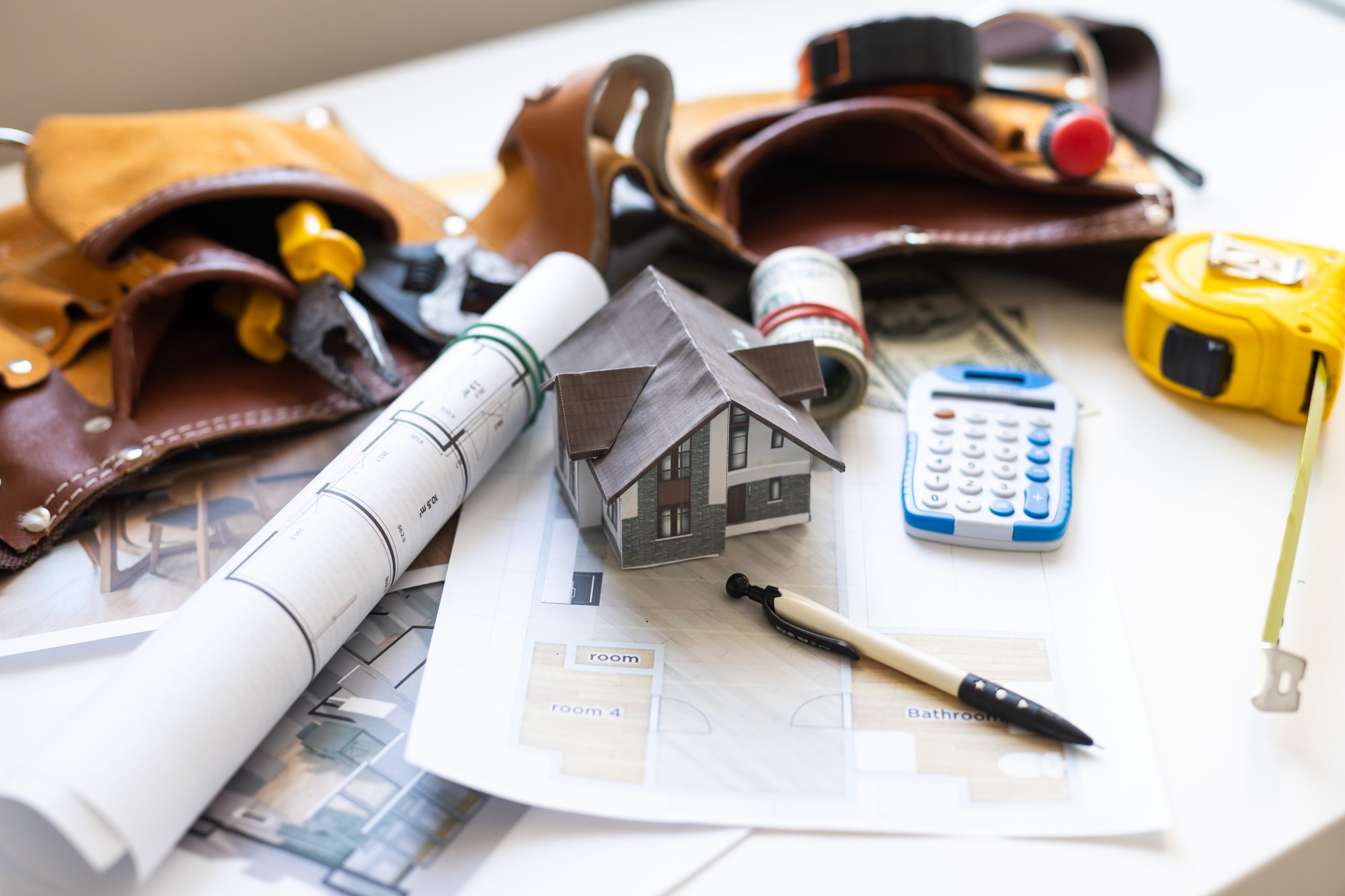 building house on blueprints with worker - construction project home plans