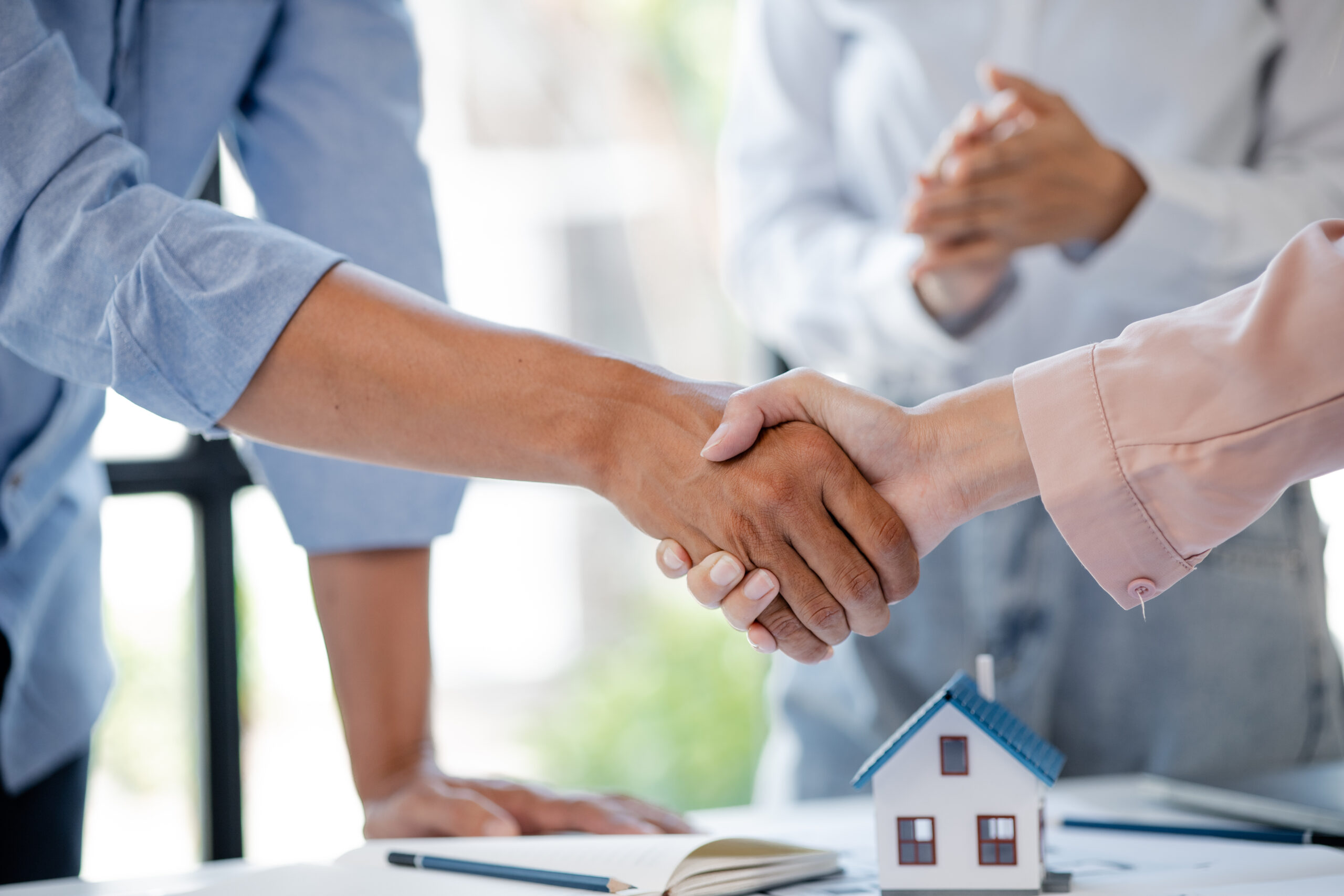 Architects who design buildings and houses shake hands with the Buying in Cramlington, Newcastle or the Tyne Valley: Local Conveyancing Issues to Watch