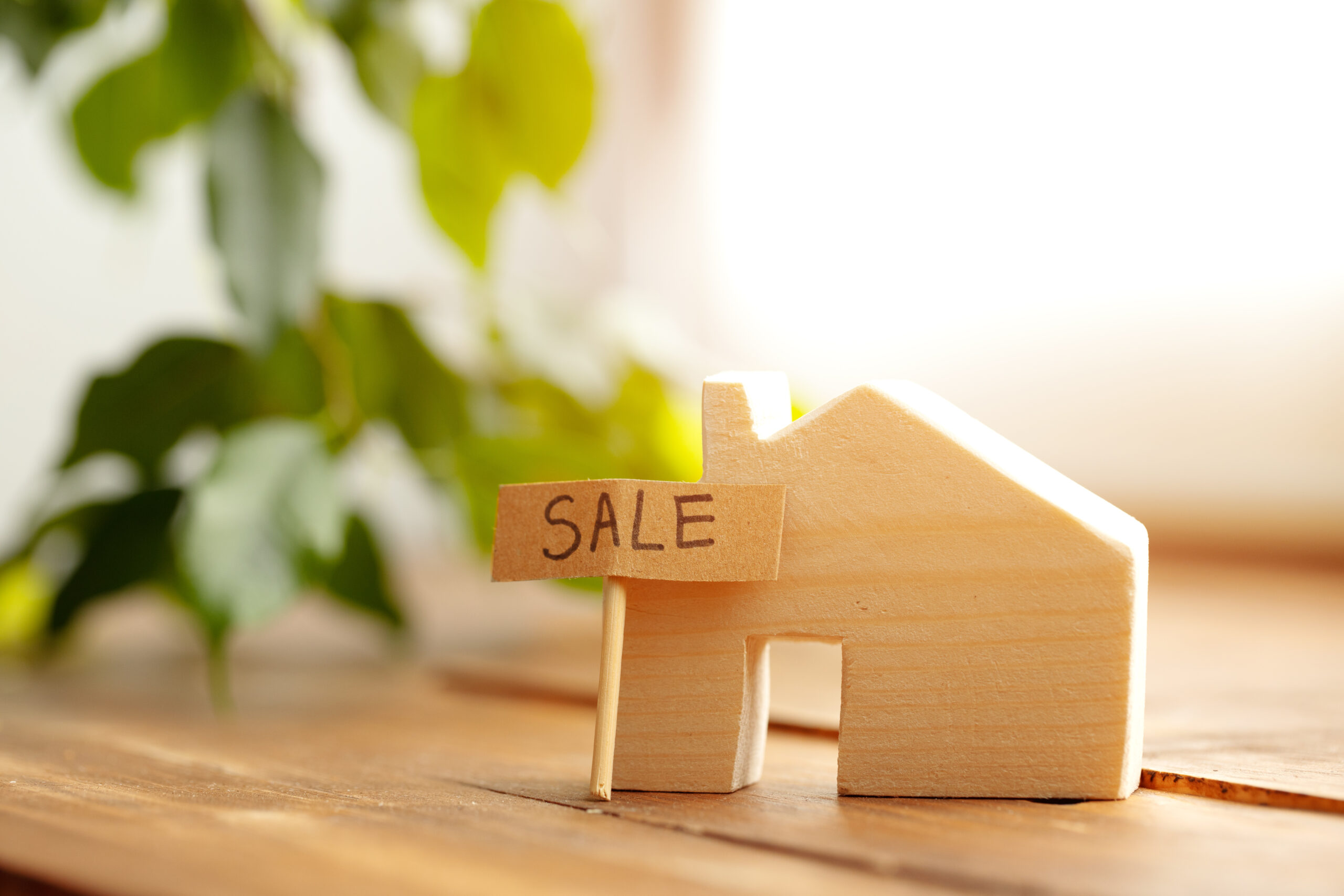 Wooden house model and for sale sign What Legal Steps Are Involved in a House Sale