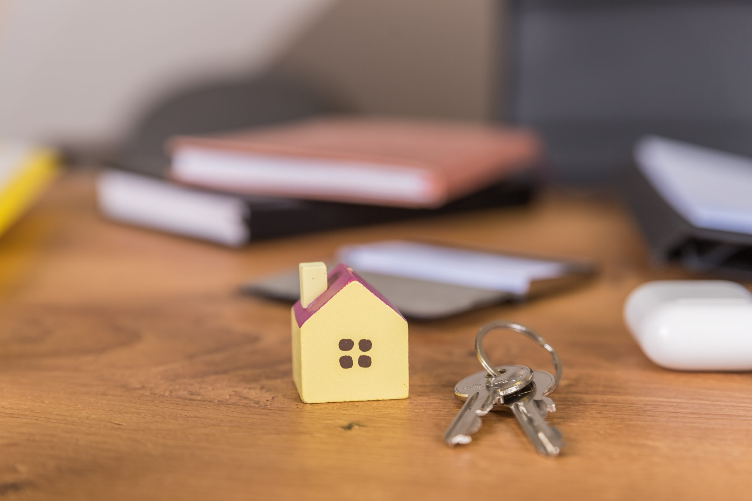Key and house shaped keychain arrangement on blurred background. Top view, flat lay. Real estate, insurance concept, mortgage, buy sell house, realtor concept What Legal Steps Are Involved in a House Sale